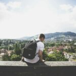 Image of a student with a backpack on campus