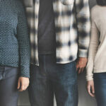 group of diverse students standing shoulder to shoulder and faces have been cropped from the photo