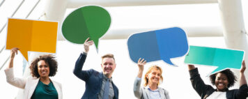 People holding up chat signs