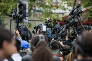 A crowd of people holding up professional camera gear.