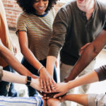 Diverse people stacking hands