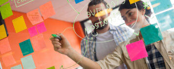 Two professionals discussing over sticky notes