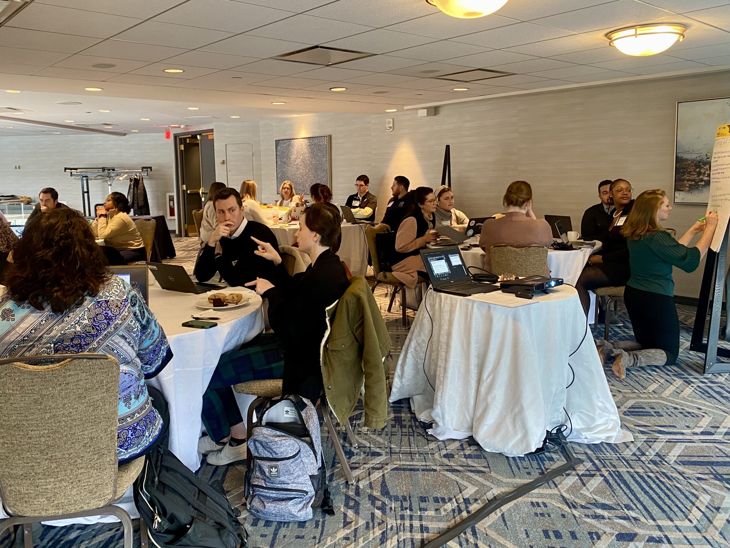 People in conversation at an Academic Impressions conference