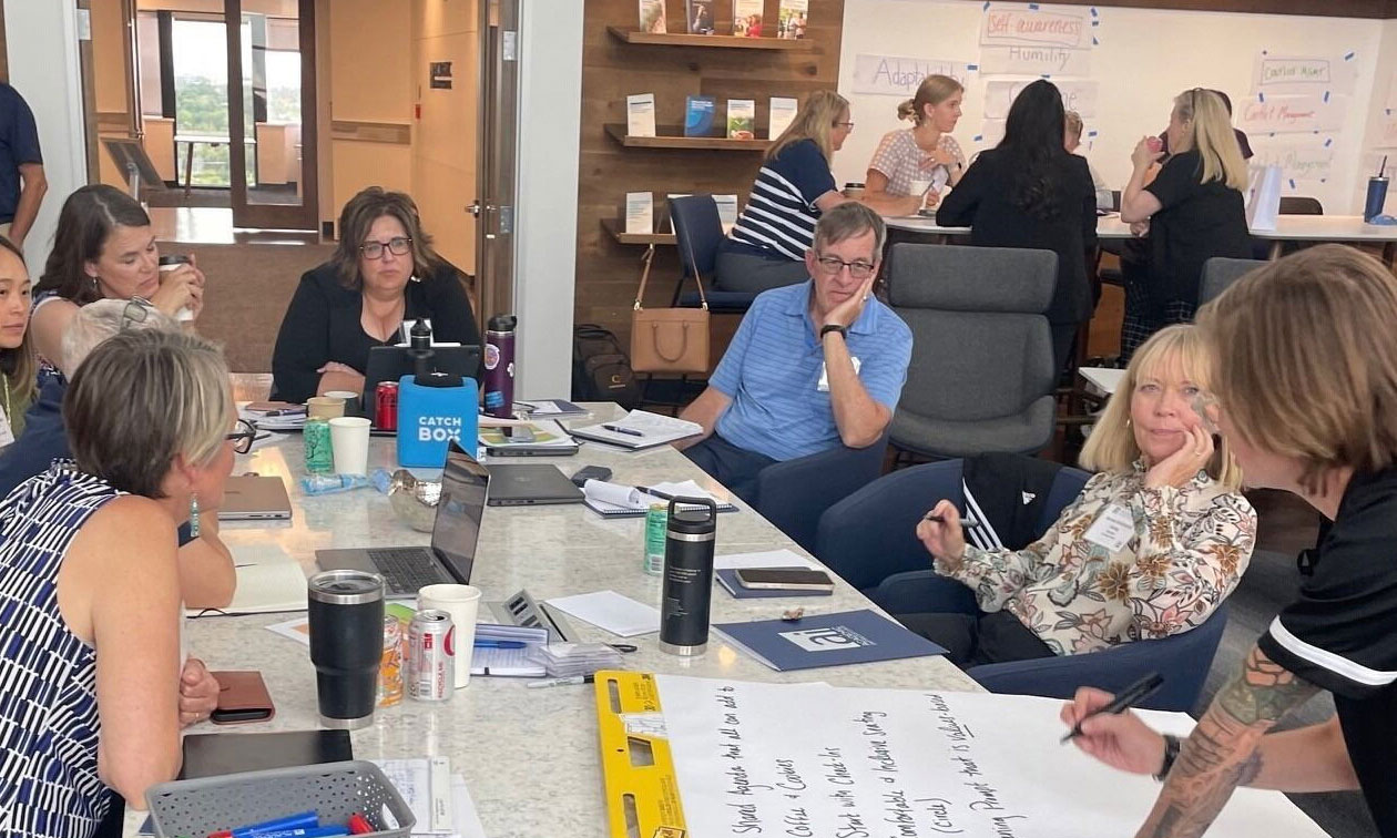 Attendees having a discussion at an Academic Impressions Workshop