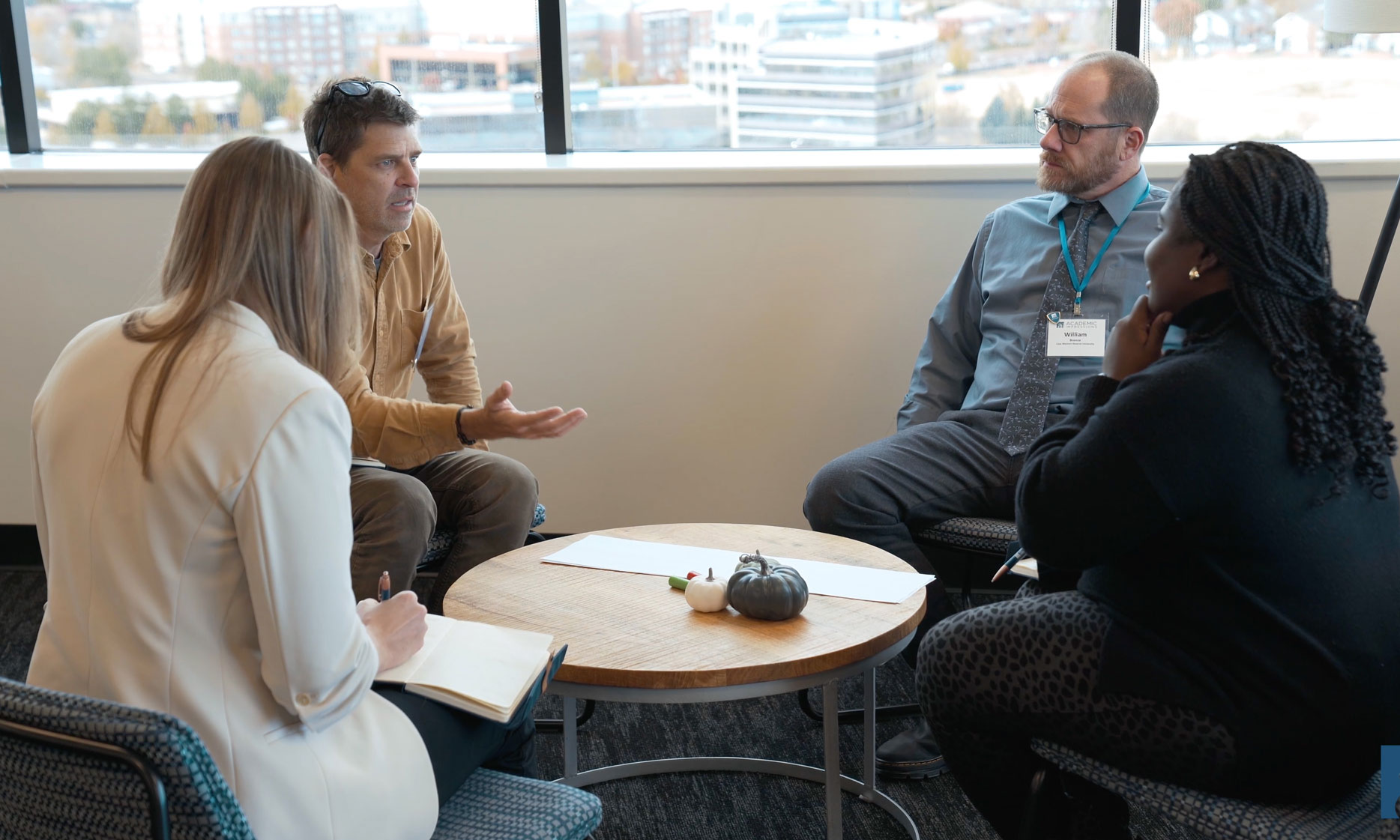 Attendees having a discussion at an Academic Impressions Workshop