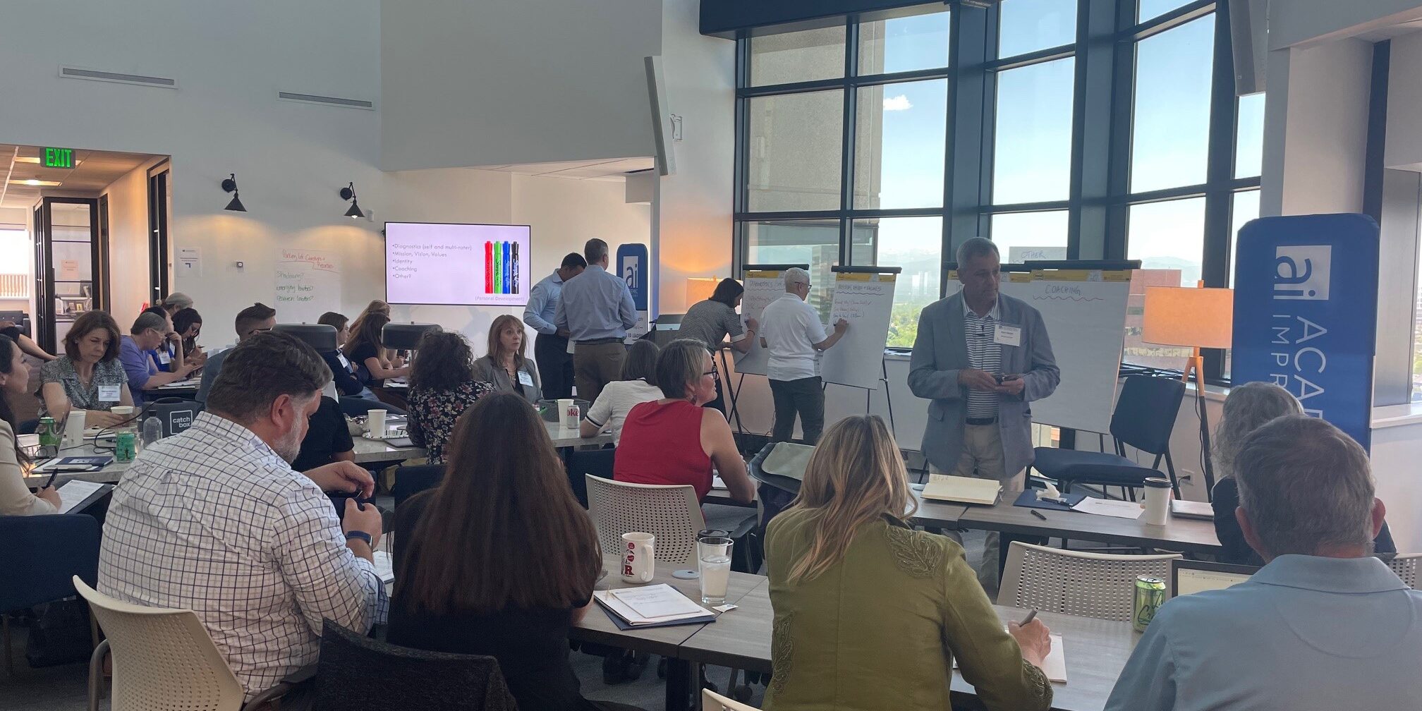 People in conversation at an Academic Impressions conference